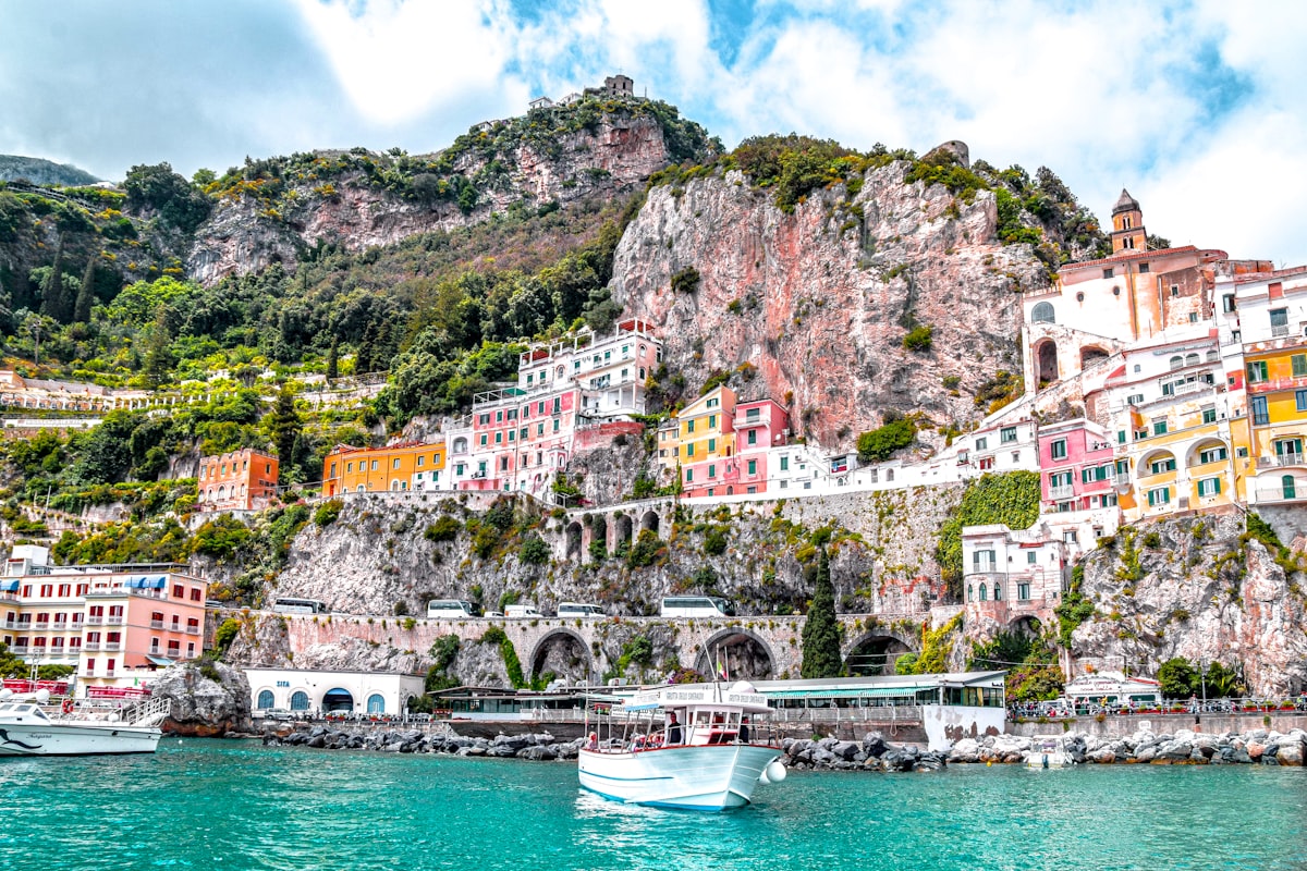 A colorful cliffside village above turquoise water on the Amalfi Coast, Italy