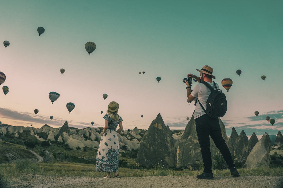 Hot air balloons drifting over Cappadocia at dawn